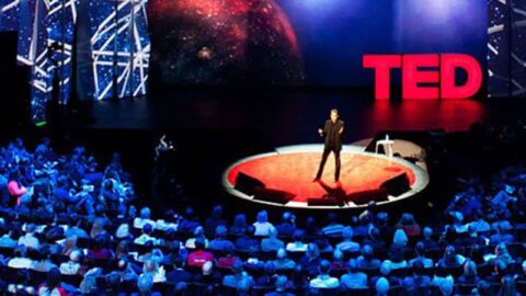 Man giving a TED talk on stage