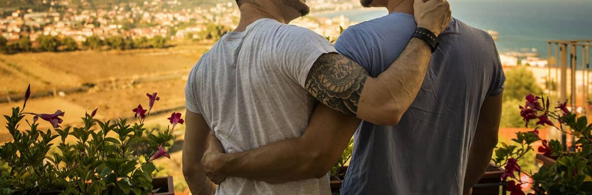 Two men with arms around each other