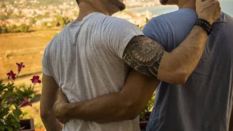 Two men with arms around each other