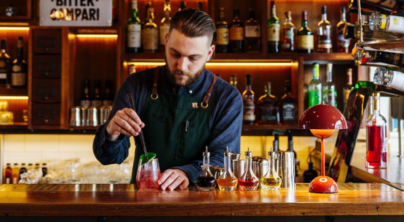 bartender stirs a cocktail at the attic in the black pearl melbourne