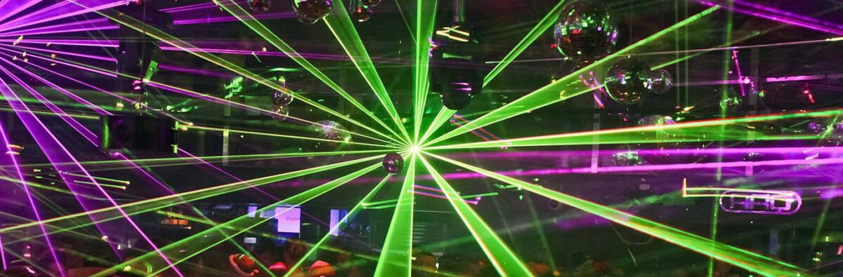 Green and pink club lights in busy nightclub in Sydney