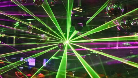 Green and pink club lights in busy nightclub in Sydney