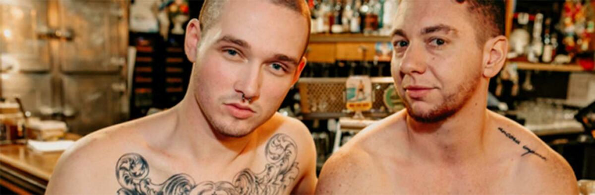 2 topless trans men at a bar