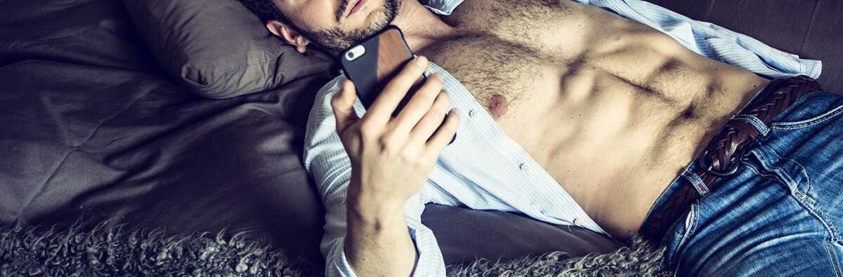 Man-with-open-shirt-on-phone