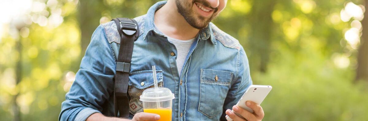 Man smiling after receiving some good news on his phone