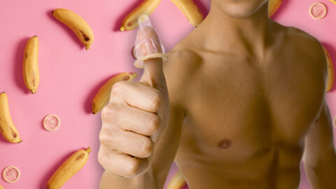 Shirtless man with condom on thumb, pink condom and banana background background