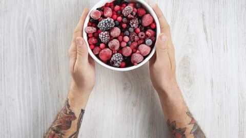 Man holding a bowl of berries