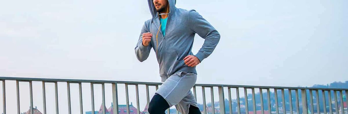 Man running with hoodie and skins