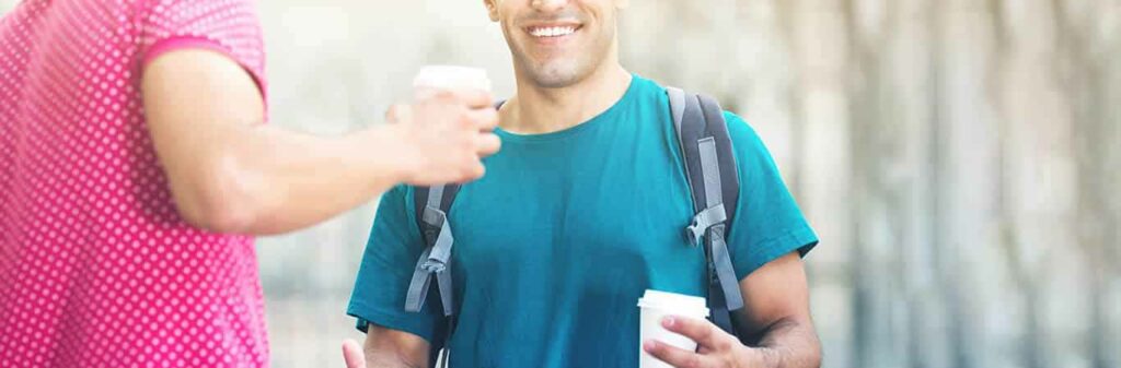 Smiling man having a takeaway coffee