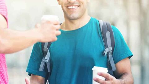 Smiling man having a takeaway coffee