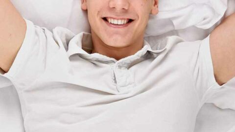 Happy man smiling in bed