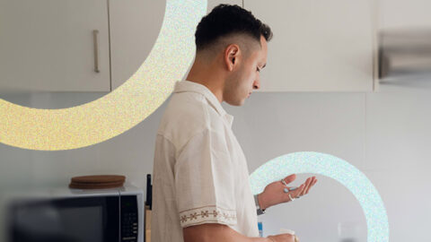 mid-shot-colombian-man-holds-single-pill-yellow-blue-circles