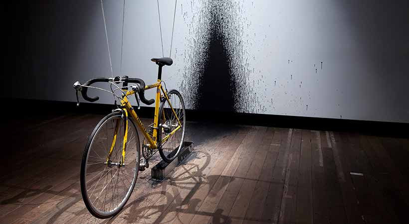 MONA hobart bicycle wheel spattering ink on wall