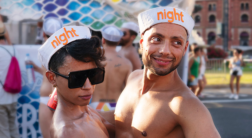 gay couple wearing sailor hats at gay pride barcelona