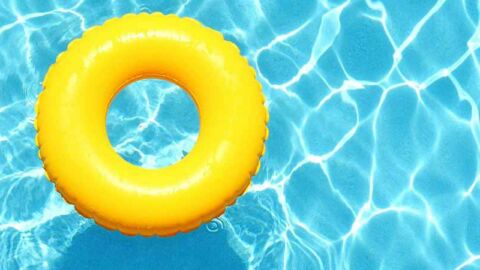 yellow inflatable rubber ring floating in swimming pool