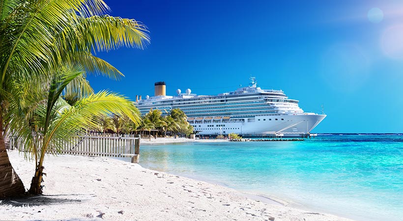 luxury cruise ship in port by the beach