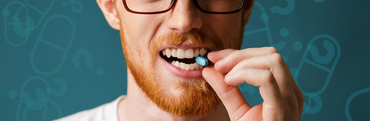 red haired man biting prep pill