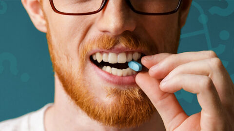red haired man biting prep pill