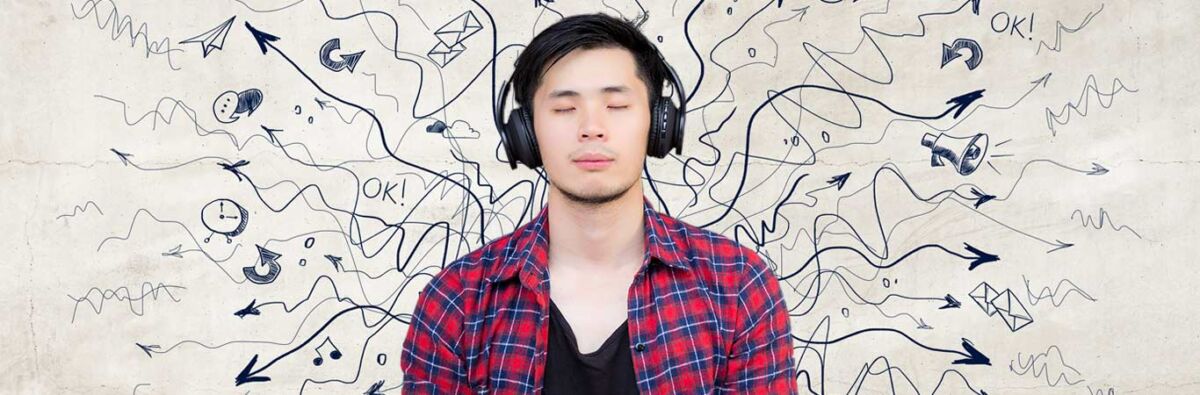 young man in plaid shirt chills with headphones against a backdrop of chaos