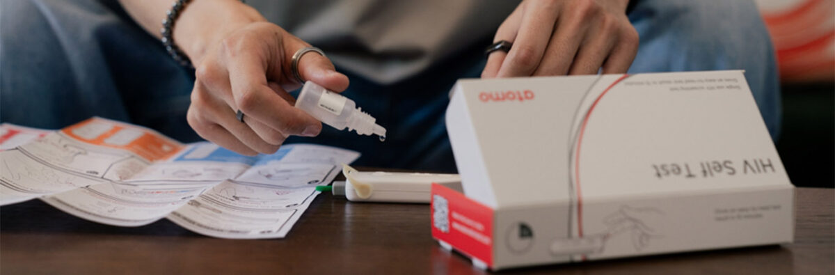 Mans hands doing a HIV self-test kit