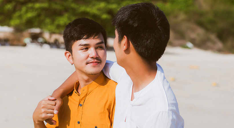 Asian gay couple sharing a happy moment on the beach