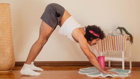 Young First Nations man doing yoga pose at home