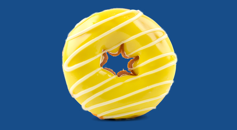yellow glazed donut on blue background