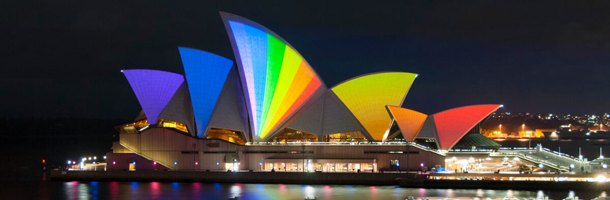 sails of sydney opera house lit up in rainbow colours