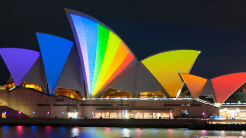 sails of sydney opera house lit up in rainbow colours