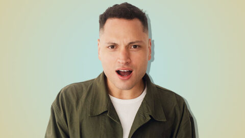 Colombian man shocked on blue yellow background