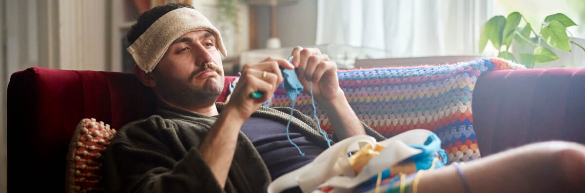 sick-man-crocheting-on-couch