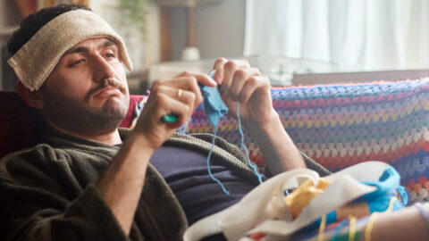 sick-man-crocheting-on-couch