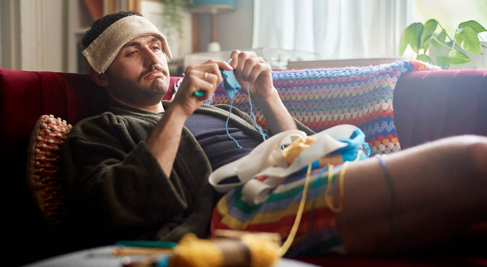 sick-man-crocheting-on-couch