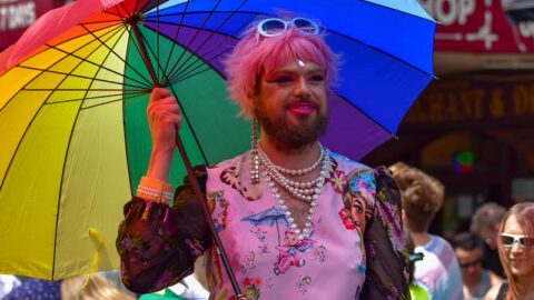 drag queen holding rainbow umbrella at melbourne pride march
