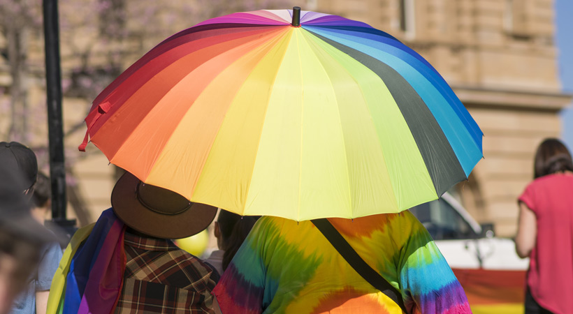 people under rainbow umbrella brisbane australia