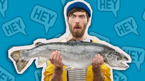 surprised man holds up large fish with speech bubbles in background to show catfishing