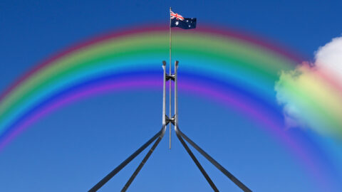 rainbow over top of parliament house in canberra