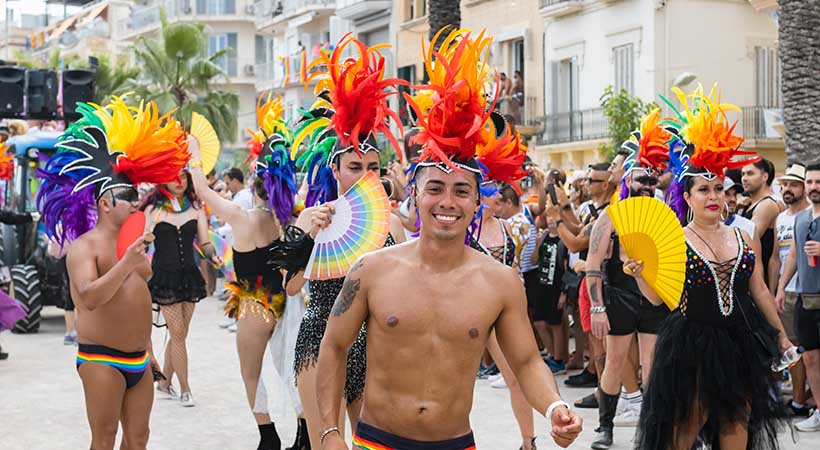 Smiling man celebrating pride event in Sitges