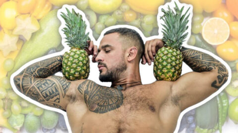muscly-tattoed-man-holding-two-pineapples-rainbow-fruit
