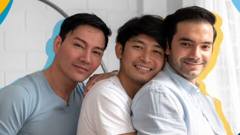 threesome-of-three-happy-asian-guys-in-living-room-with-colourful-circle-elements