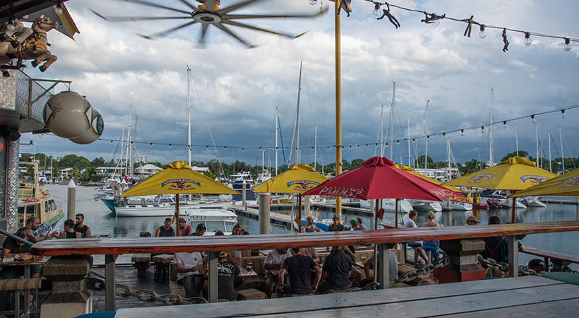 Darwin, Northern Territory, Australia-November 26,2017: Cullen Bay marina and people eating outside at Lola's Pergola restaurant during a tropical storm in Darwin, Australia