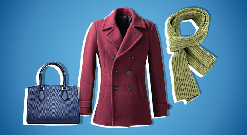 Blue bag, red coat and green scarf on blue background