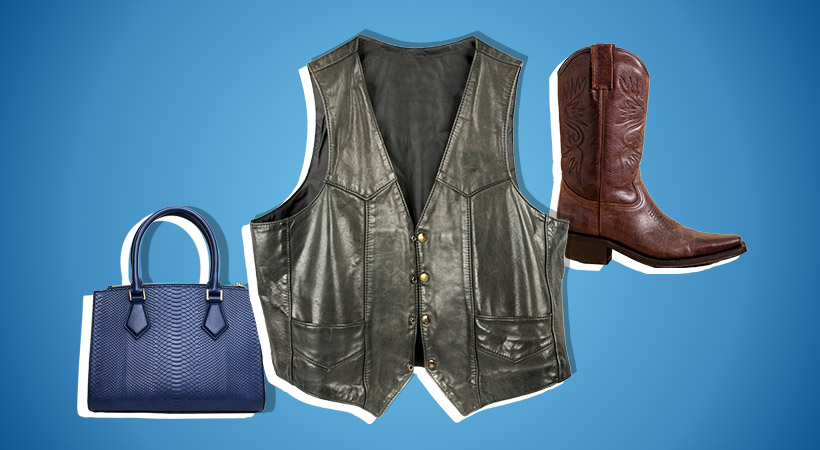 Leather bag, vest and boots on blue gradient background