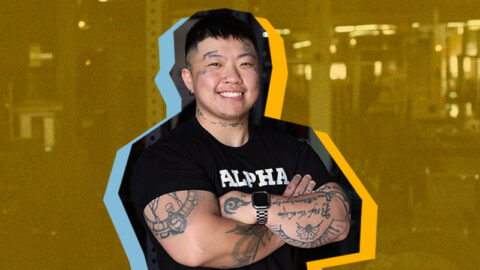 Tats-gym-coach-in-black-ALPHA-shirt-with-colourful-shadows-on-yellow-background