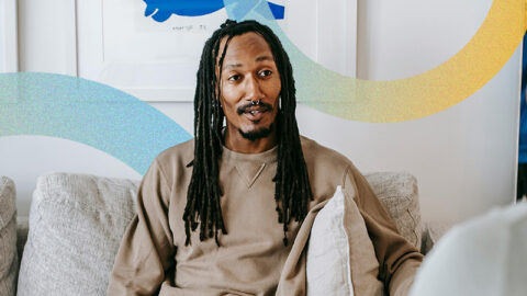 black-guy-with-long-hair-talks-to-therapist-with-two-blue-circle