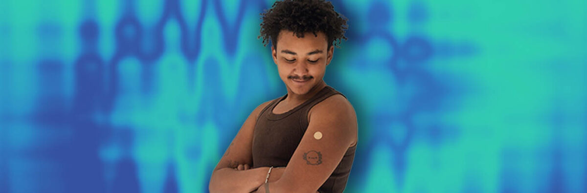 Ghanian man smiling at injection bandaid on blue background