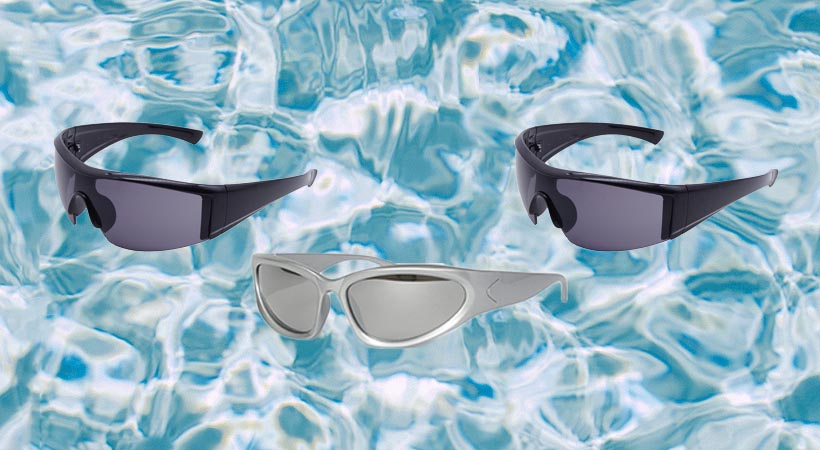 Two black and one silver pair of sunglasses on water background