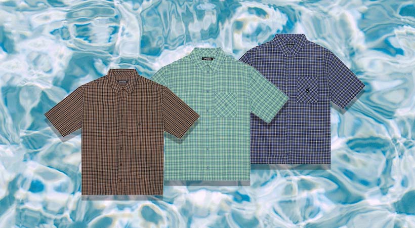 Three button-up summer shirts on water background