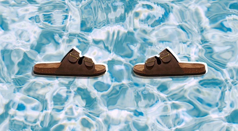 Two brown sandals on water background
