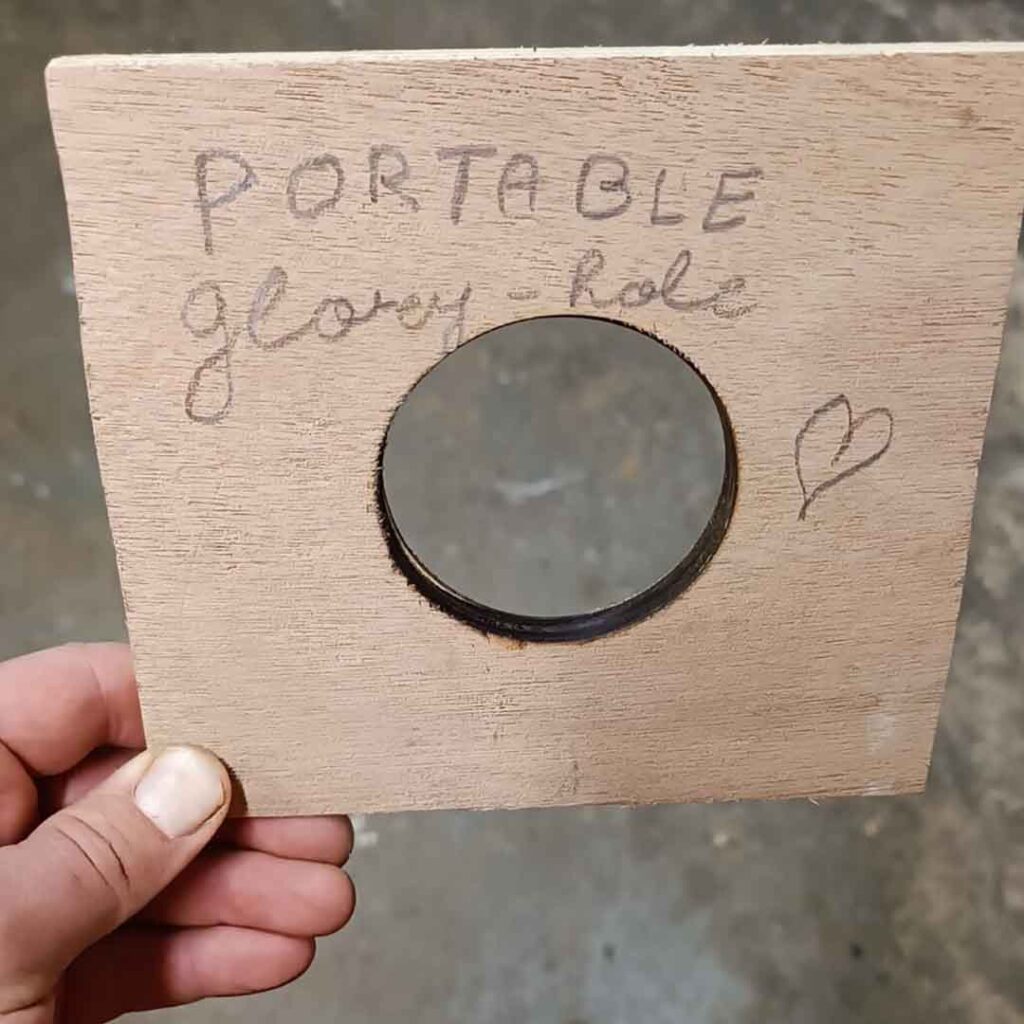 A wooden square with a circle cut out of it